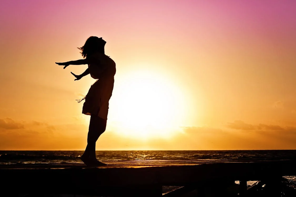 Lady in Beach Silhouette during Daytime Phenomenon; Dawn Phenomenom