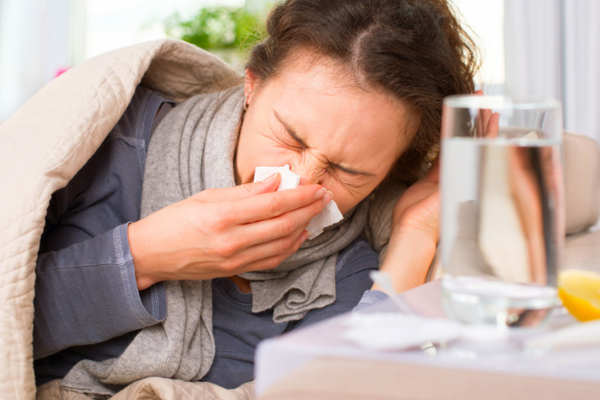 Sick Woman. Flu. Woman Caught Cold. Sneezing into Tissue 